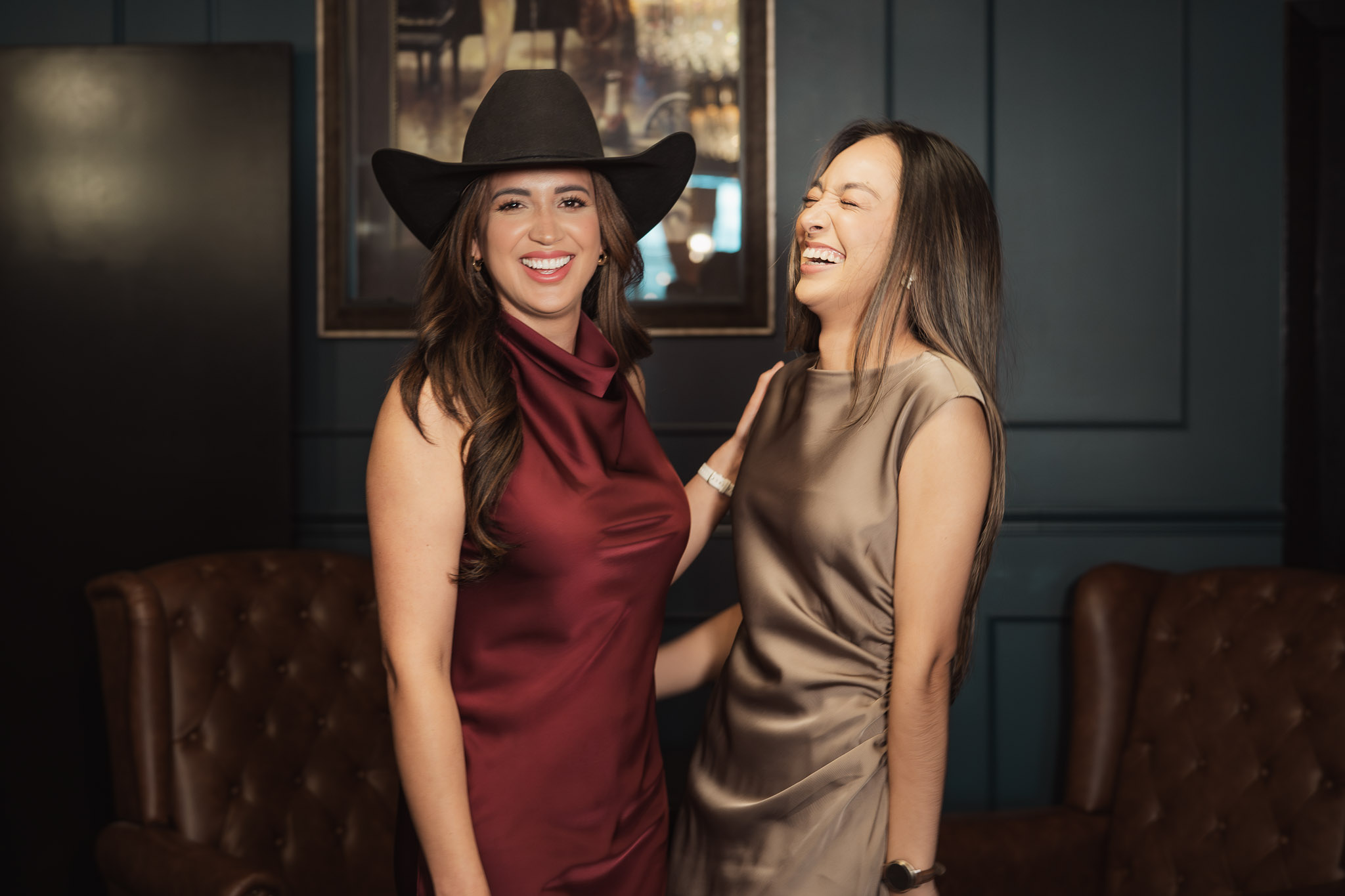Two agents laughing together at Sage Speakeasy